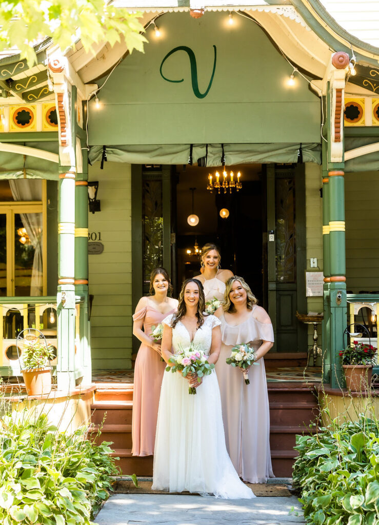 Beautiful bridal party gathers at the entrance to the Vandiver Inn Havre De Grace, wedding photography