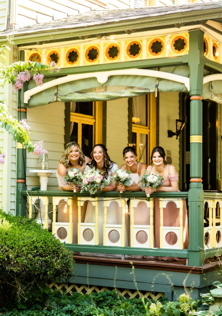 Bridesmaids gather on the porch railing, Vandiver Inn Havre De Grace, wedding photography