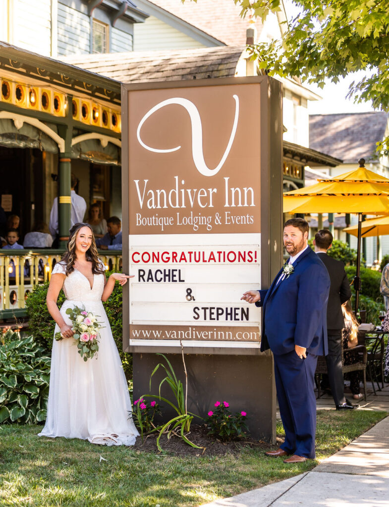 Couple posing at their custom marquee at the Vandier Inn Havre De Grace, wedding photography